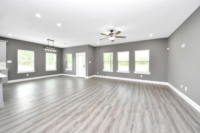 601 Lily St, Waller, TX 77484 - unfurnished living room with a ceiling fan, recessed lighting, and light wood finished floors