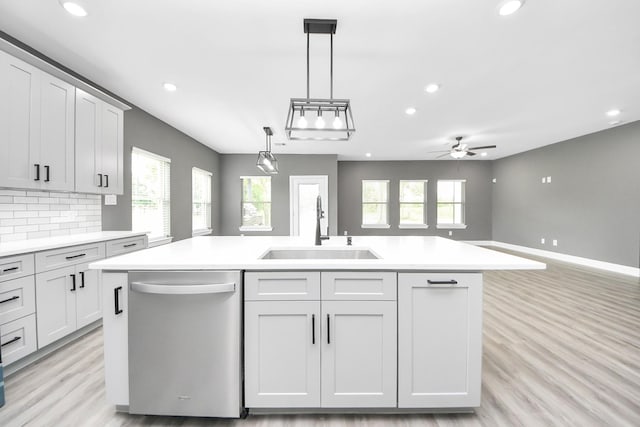 601 Lily St, Waller, TX 77484 - kitchen with stainless steel dishwasher, a kitchen island with sink, light countertops, recessed lighting, and light wood-style floors
