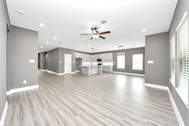 601 Lily St, Waller, TX 77484 - unfurnished living room with a ceiling fan, light wood-type flooring, and recessed lighting
