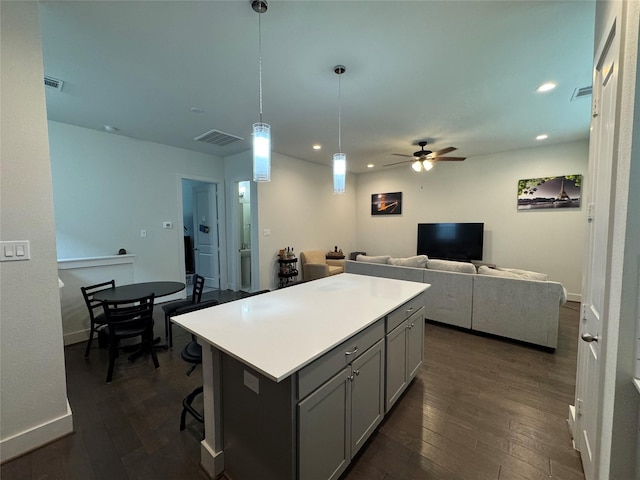 6031 Cypress St, Houston, TX 77074 - kitchen featuring gray cabinetry, ceiling fan, dark wood-style floors, recessed lighting, and a kitchen island