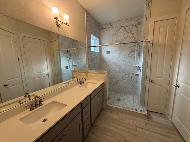 6031 Cypress St, Houston, TX 77074 - bathroom featuring a marble finish shower and double vanity