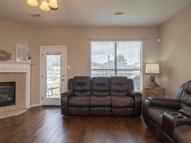 19327 Dickson Park Dr, Spring, TX 77373 - living room with dark wood finished floors, a tiled fireplace, and healthy amount of natural light