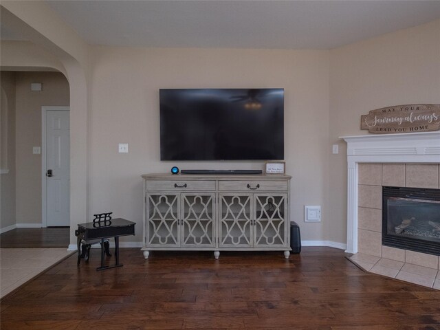 19327 Dickson Park Dr, Spring, TX 77373 - living area featuring arched walkways, wood finished floors, and a tiled fireplace