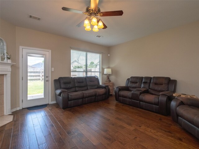 19327 Dickson Park Dr, Spring, TX 77373 - living area featuring dark wood-type flooring, ceiling fan, and a fireplace
