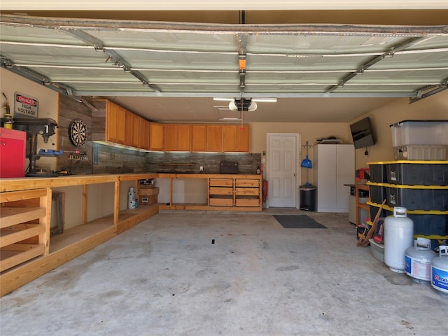 19327 Dickson Park Dr, Spring, TX 77373 - garage featuring a workshop area and a garage door opener