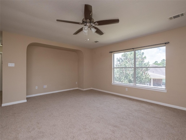 19327 Dickson Park Dr, Spring, TX 77373 - empty room with ceiling fan, arched walkways, and carpet floors