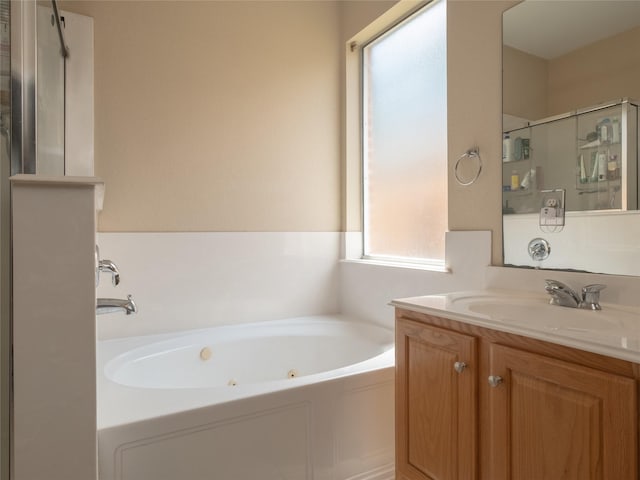 19327 Dickson Park Dr, Spring, TX 77373 - bathroom with a jetted tub, vanity, and a stall shower