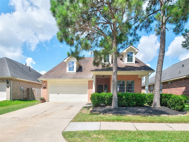 19327 Dickson Park Dr, Spring, TX 77373 - view of front of house with brick siding, driveway, an attached garage, and a shingled roof