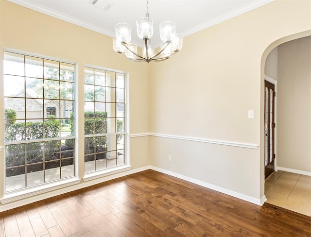 19327 Dickson Park Dr, Spring, TX 77373 - spare room with arched walkways, a chandelier, wood finished floors, and ornamental molding