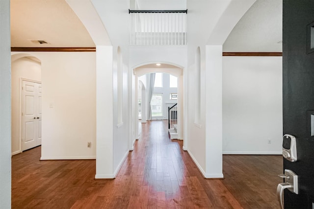 13811 Pepperstone Ln, Houston, TX 77044 - corridor featuring arched walkways, wood finished floors, and stairs