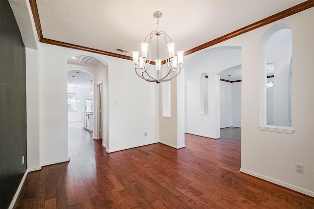 13811 Pepperstone Ln, Houston, TX 77044 - empty room with dark wood-type flooring, a chandelier, ornamental molding, and arched walkways