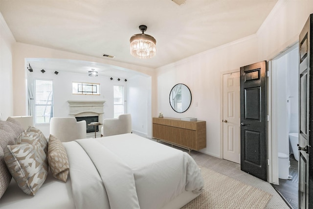 13811 Pepperstone Ln, Houston, TX 77044 - bedroom with a chandelier, carpet floors, and a fireplace