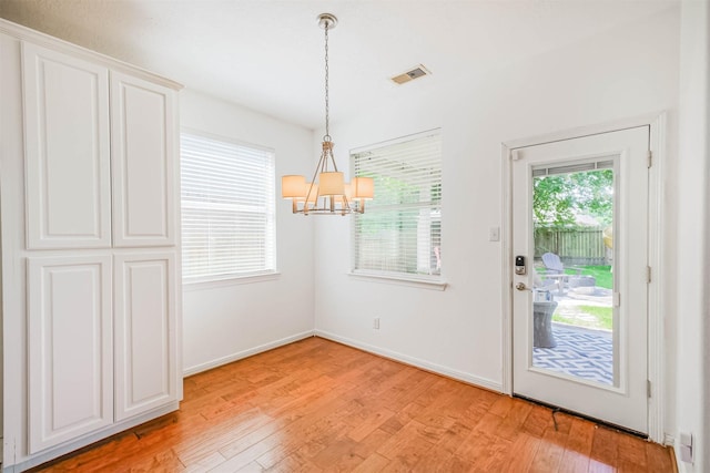 13811 Pepperstone Ln, Houston, TX 77044 - unfurnished dining area with a chandelier and light wood-type flooring