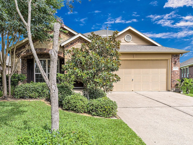 10163 Rose Willow Ln, Brookshire, TX 77423 - view of front of property with brick siding, an attached garage, driveway, a shingled roof, and a front yard
