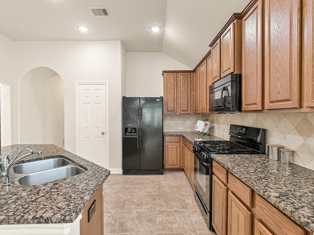 10163 Rose Willow Ln, Brookshire, TX 77423 - kitchen featuring black appliances, decorative backsplash, vaulted ceiling, dark stone counters, and recessed lighting
