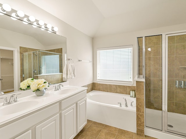 10163 Rose Willow Ln, Brookshire, TX 77423 - bathroom with vaulted ceiling, a stall shower, a bath, double vanity, and tile patterned floors
