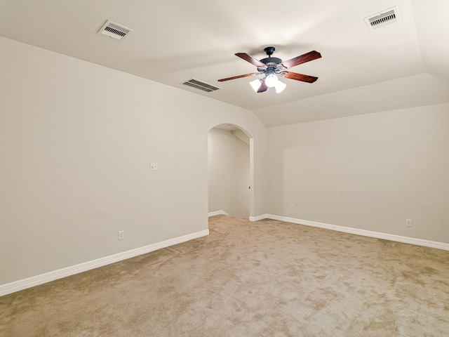10163 Rose Willow Ln, Brookshire, TX 77423 - empty room with a ceiling fan, arched walkways, light colored carpet, and lofted ceiling