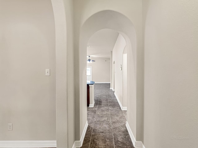 10163 Rose Willow Ln, Brookshire, TX 77423 - hall with arched walkways and dark tile patterned flooring