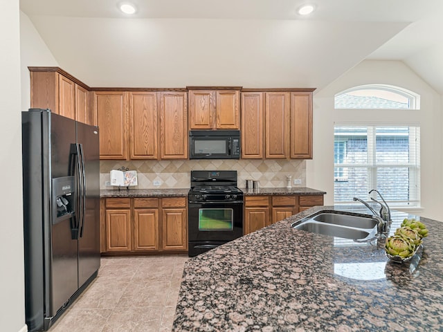 10163 Rose Willow Ln, Brookshire, TX 77423 - kitchen with black appliances, lofted ceiling, brown cabinetry, decorative backsplash, and recessed lighting