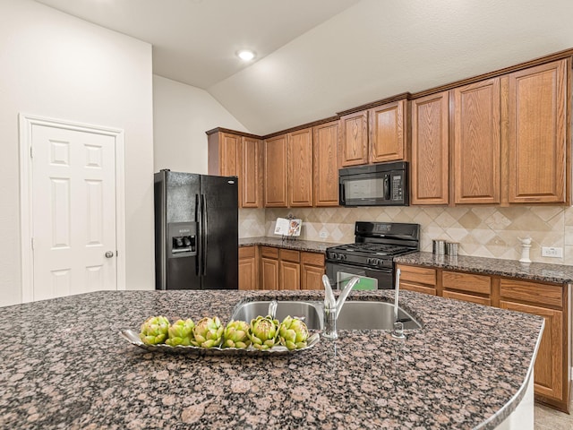10163 Rose Willow Ln, Brookshire, TX 77423 - kitchen featuring black appliances, vaulted ceiling, brown cabinets, backsplash, and dark stone countertops