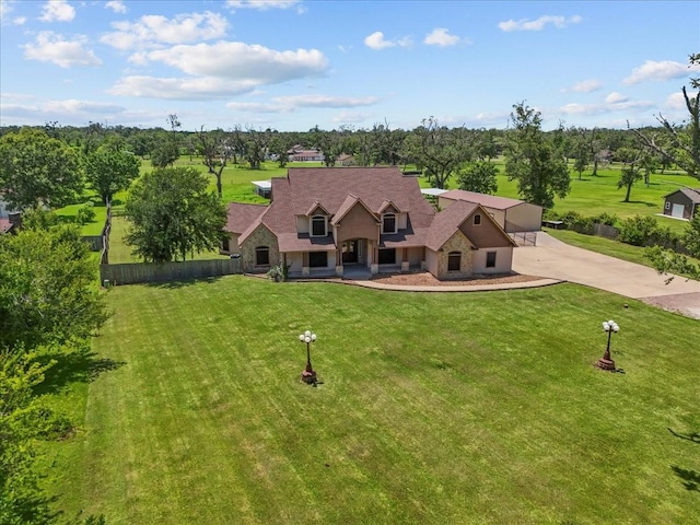 1273 County Road 201a, Angleton, TX 77515 - view of front of house with concrete driveway, stone siding, and view of scattered trees