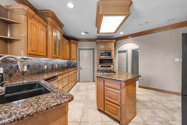 1273 County Road 201a, Angleton, TX 77515 - kitchen featuring stainless steel appliances, ornamental molding, backsplash, dark stone counters, and a center island