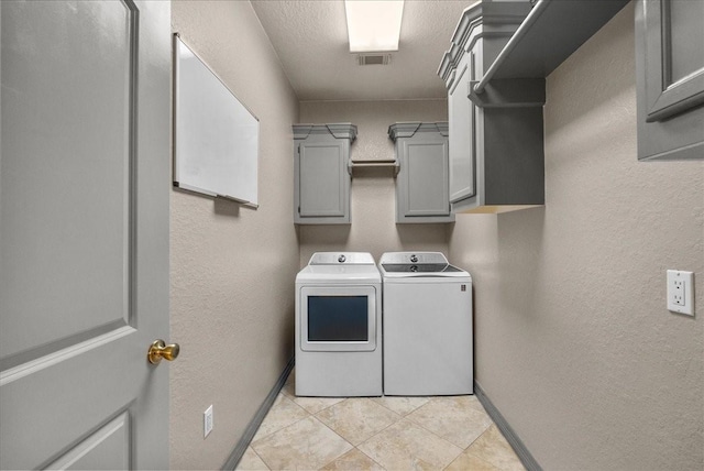1273 County Road 201a, Angleton, TX 77515 - laundry area with independent washer and dryer, cabinet space, a textured wall, and light tile patterned floors