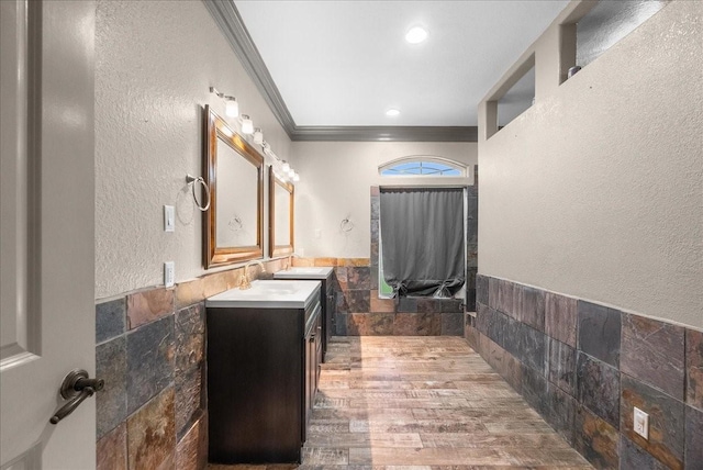 1273 County Road 201a, Angleton, TX 77515 - bathroom featuring ornamental molding, vanity, tile walls, wood finished floors, and wainscoting