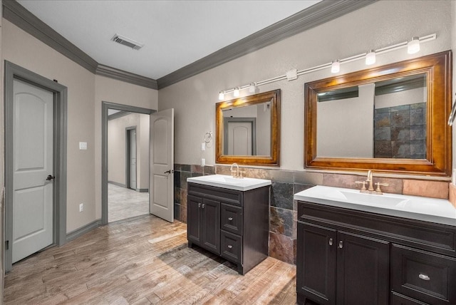 1273 County Road 201a, Angleton, TX 77515 - full bathroom with ornamental molding, two vanities, tile walls, wood finished floors, and wainscoting