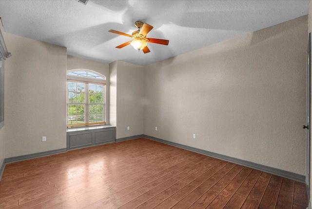1273 County Road 201a, Angleton, TX 77515 - unfurnished room featuring wood finished floors, a ceiling fan, a textured wall, and a textured ceiling