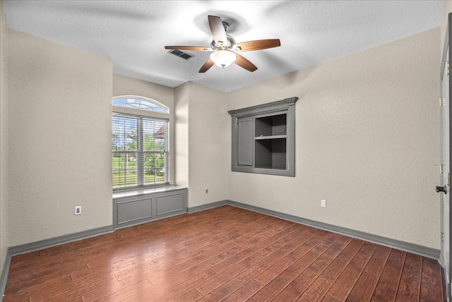 1273 County Road 201a, Angleton, TX 77515 - unfurnished room featuring ceiling fan, wood finished floors, and a textured wall