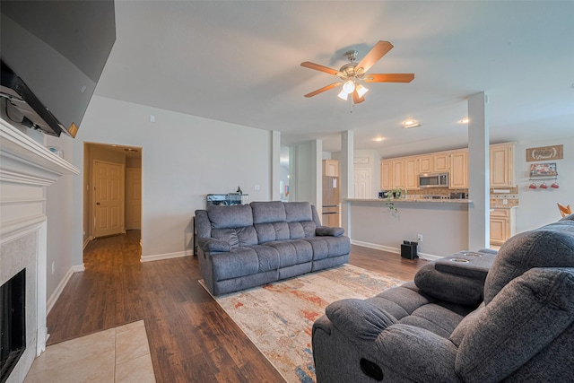 12005 Green Falls Dr, Pearland, TX 77584 - living room with wood finished floors, ceiling fan, a high end fireplace, and recessed lighting