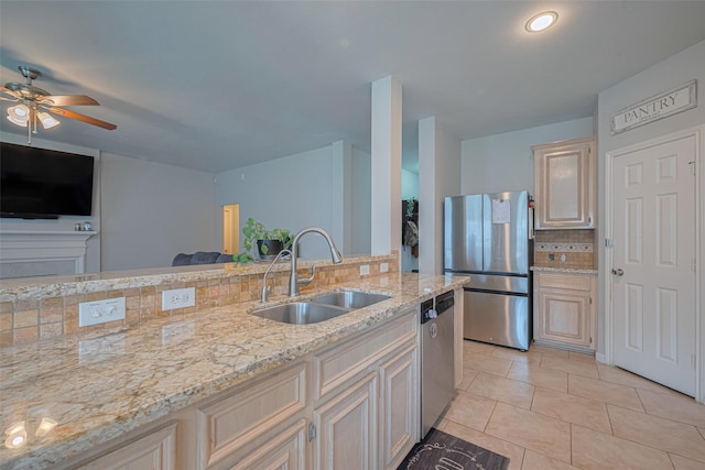 12005 Green Falls Dr, Pearland, TX 77584 - kitchen with stainless steel appliances, open floor plan, backsplash, a ceiling fan, and light stone counters
