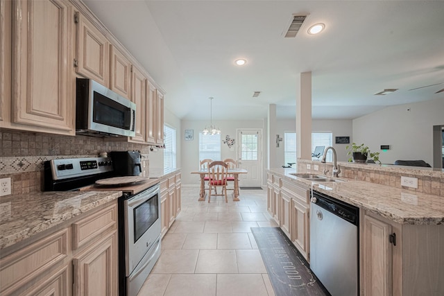 12005 Green Falls Dr, Pearland, TX 77584 - kitchen with appliances with stainless steel finishes, tasteful backsplash, light tile patterned flooring, recessed lighting, and light stone counters