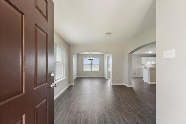 1019 Sawgrass Ridge Ln, Houston, TX 77073 - foyer entrance featuring arched walkways, dark wood-style flooring, and a chandelier
