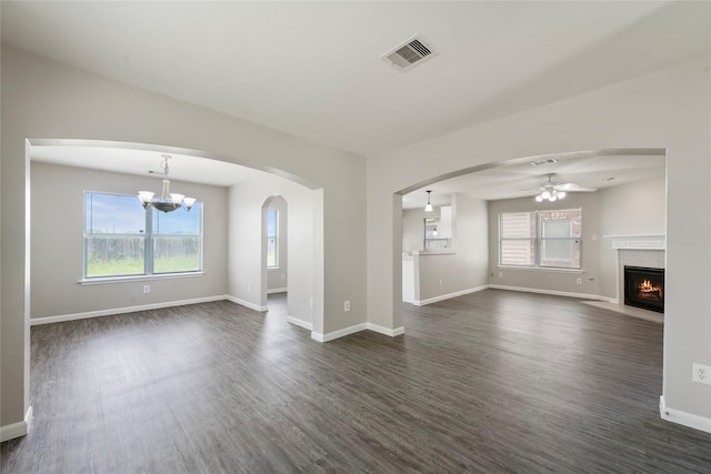 1019 Sawgrass Ridge Ln, Houston, TX 77073 - unfurnished living room with dark wood-style flooring, ceiling fan, a fireplace with flush hearth, and a chandelier