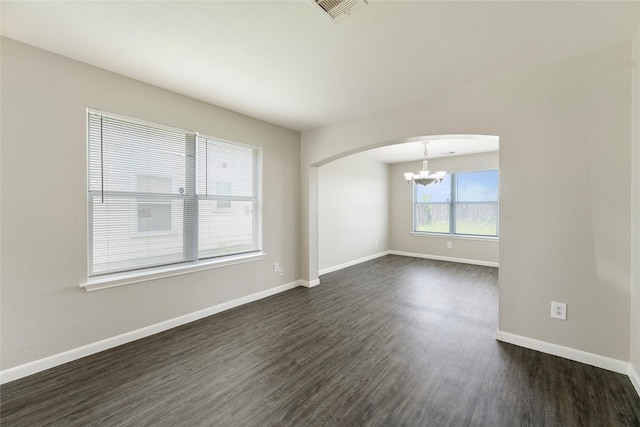 1019 Sawgrass Ridge Ln, Houston, TX 77073 - spare room with arched walkways, a chandelier, and dark wood-style floors