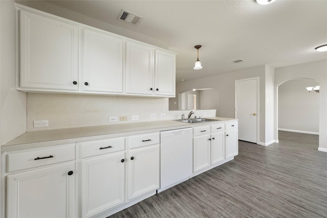 1019 Sawgrass Ridge Ln, Houston, TX 77073 - kitchen featuring white dishwasher, arched walkways, light wood-style floors, white cabinets, and light countertops