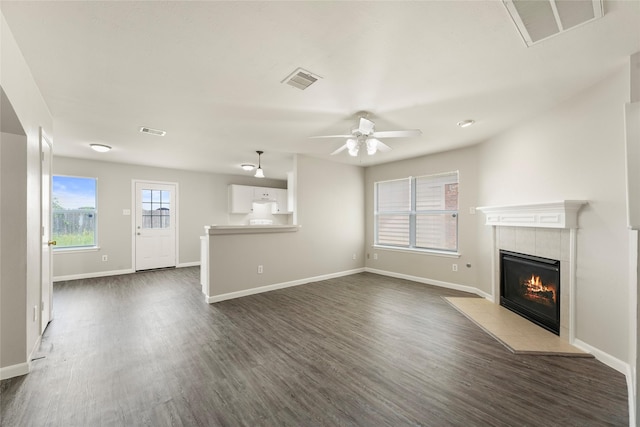 1019 Sawgrass Ridge Ln, Houston, TX 77073 - unfurnished living room with a fireplace, ceiling fan, and dark wood finished floors