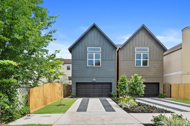 4403 Feagan, Houston, TX 77007 - view of front of home featuring board and batten siding, a garage, and driveway