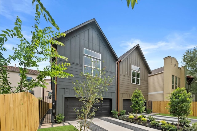 4403 Feagan, Houston, TX 77007 - view of front of property with board and batten siding, concrete driveway, and an attached garage