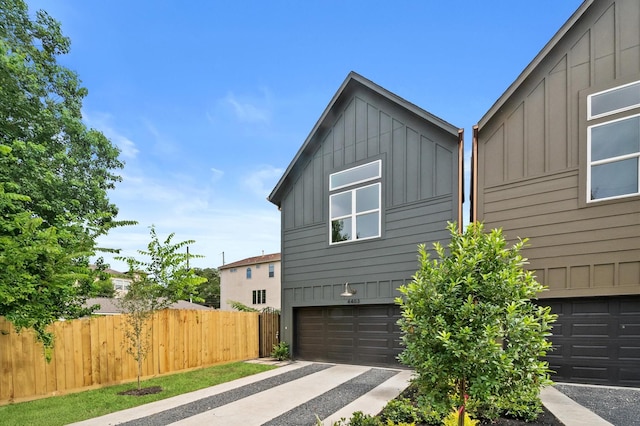 4403 Feagan, Houston, TX 77007 - view of property exterior with board and batten siding, an attached garage, and driveway