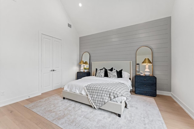 4403 Feagan, Houston, TX 77007 - bedroom featuring light wood-style floors, high vaulted ceiling, a closet, wooden walls, and recessed lighting