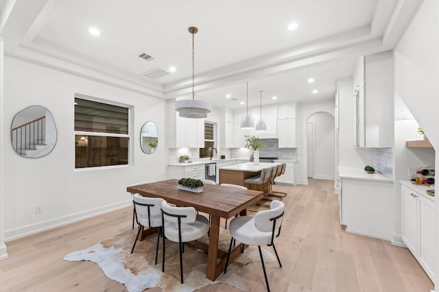 4403 Feagan, Houston, TX 77007 - dining space with light wood-style floors, recessed lighting, a raised ceiling, and arched walkways