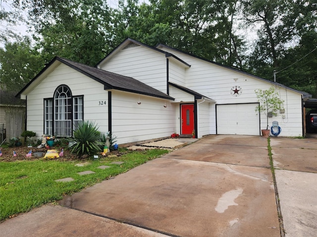 324 E Hunting Tower Run, Montgomery, TX 77316 - view of front facade featuring a garage, driveway, and a shingled roof