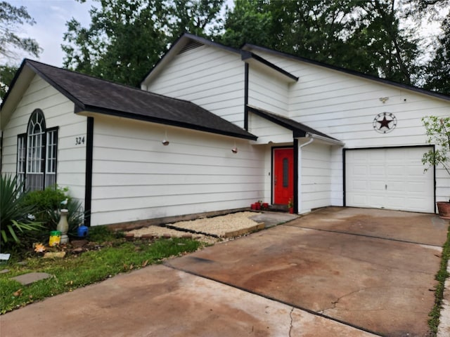 324 E Hunting Tower Run, Montgomery, TX 77316 - view of front facade with a garage, driveway, and a shingled roof