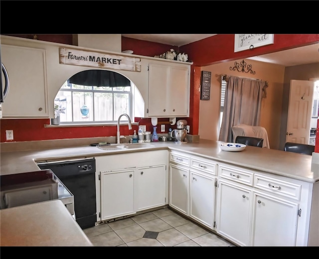 324 E Hunting Tower Run, Montgomery, TX 77316 - kitchen featuring a peninsula, light tile patterned floors, and white cabinetry