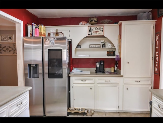 324 E Hunting Tower Run, Montgomery, TX 77316 - kitchen featuring stainless steel refrigerator with ice dispenser, light countertops, white cabinets, and light tile patterned floors