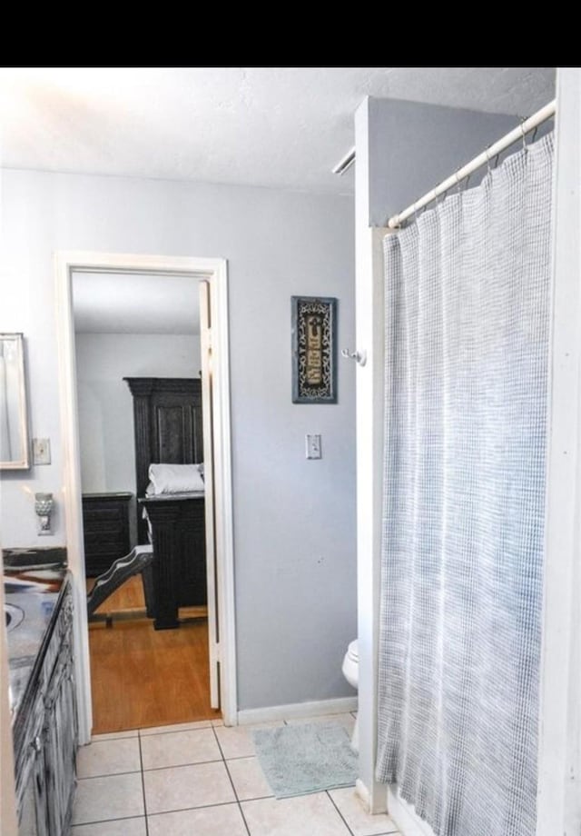 324 E Hunting Tower Run, Montgomery, TX 77316 - full bathroom with tile patterned flooring, vanity, and curtained shower