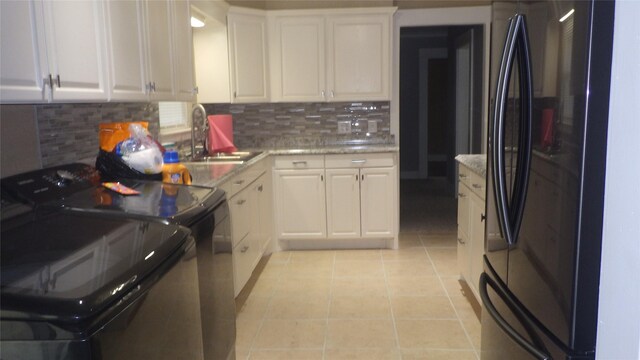 232 Birch St, Lake Jackson, TX 77566 - kitchen featuring freestanding refrigerator, range, decorative backsplash, white cabinets, and light tile patterned floors